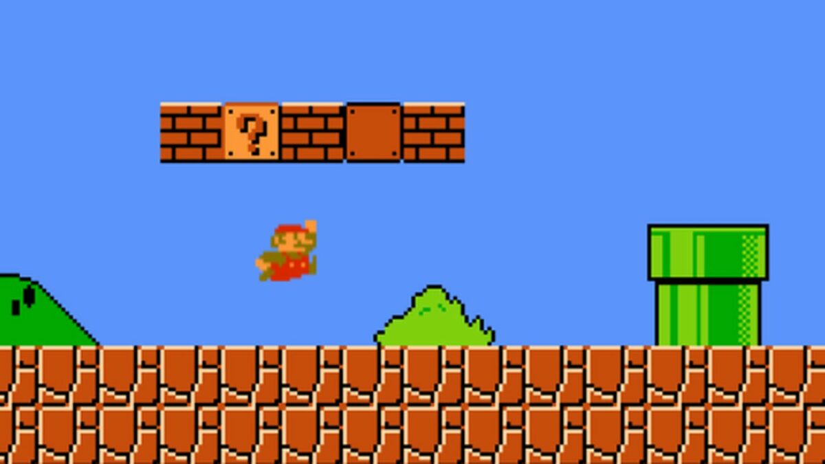 Screenshot from Super Mario Bros., with Mario jumping under a question box.