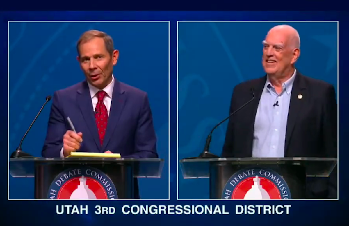 Two white men debate at podiums.