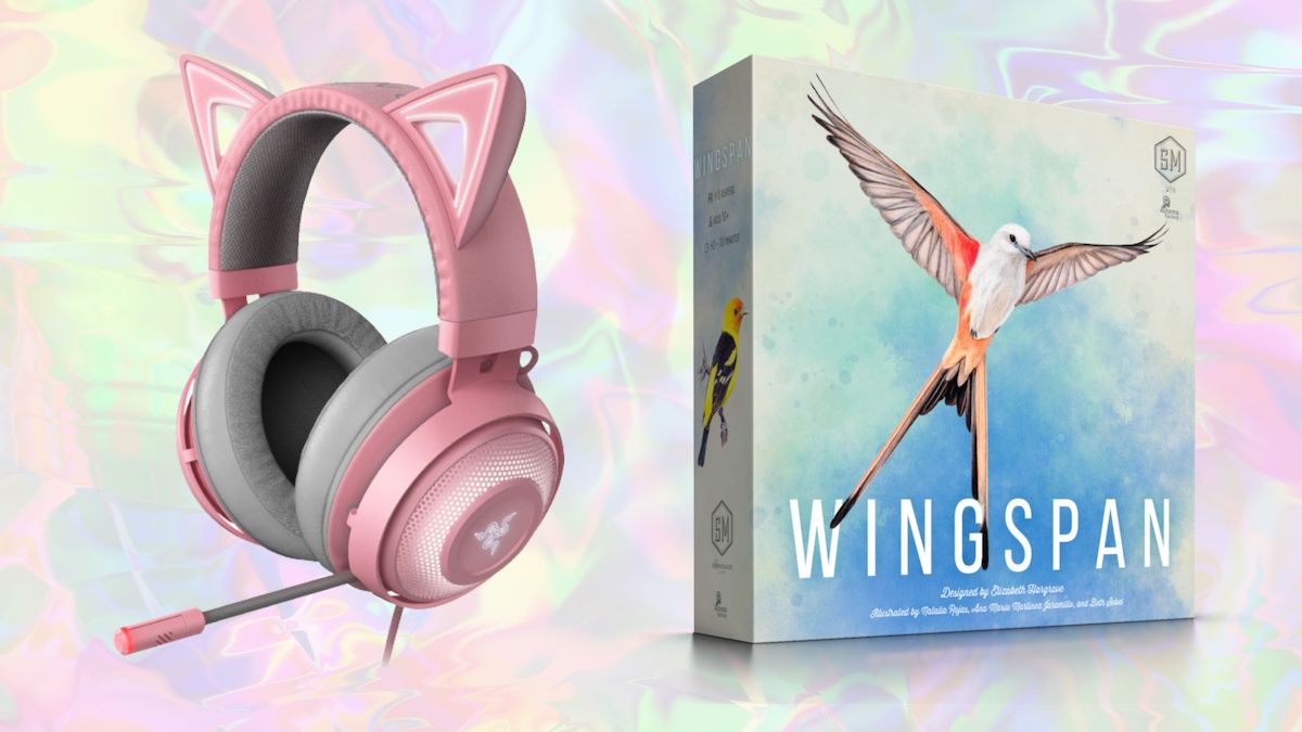 A pink gaming headset with light-up kitty ears and a the cover art for the board game Wingspan