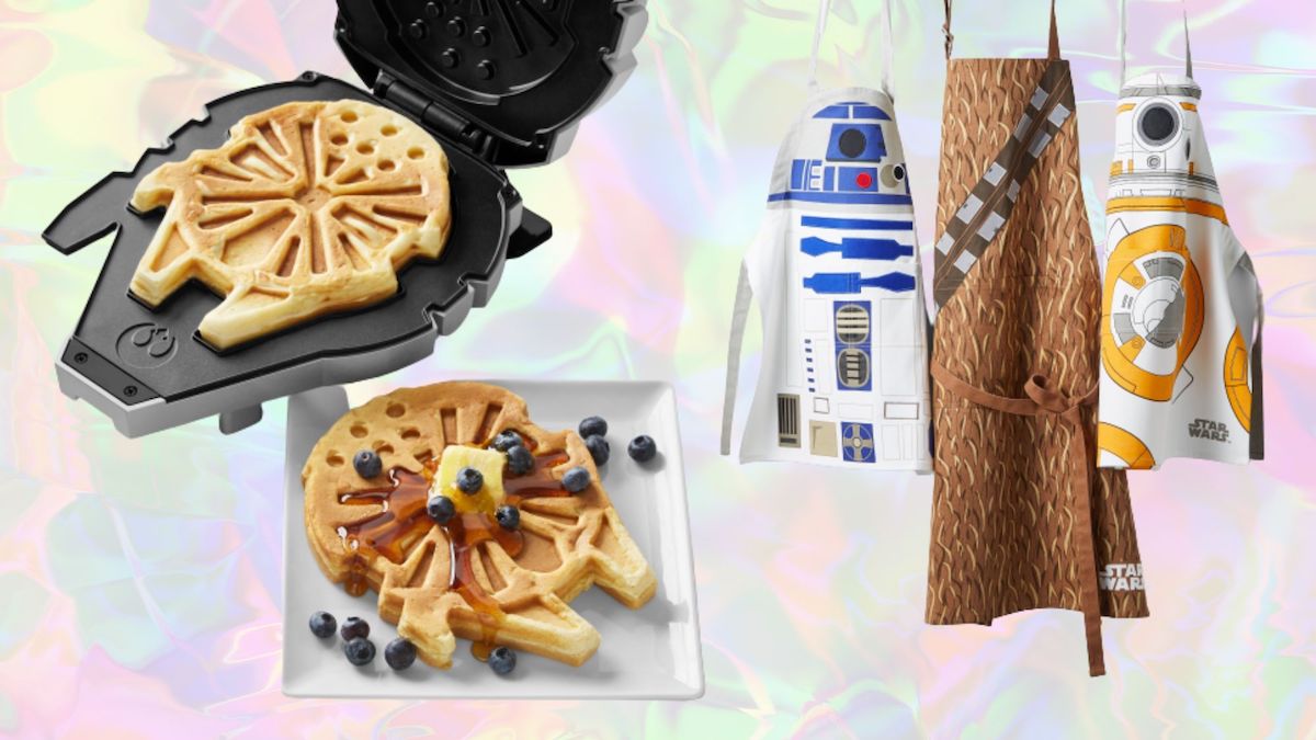 A waffle maker designed to look like the Millennium Falcon next to a plate of waffles covered in butter, maple syrup, and blueberries, and three aprons designed in the style of R2-D2, Chewbacca, and BB-8 from Star Wars