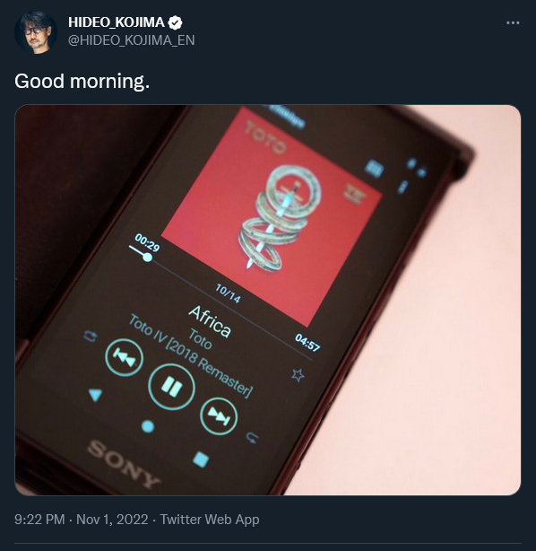 Hideo Kojima shows his smartphone while listening to Toto