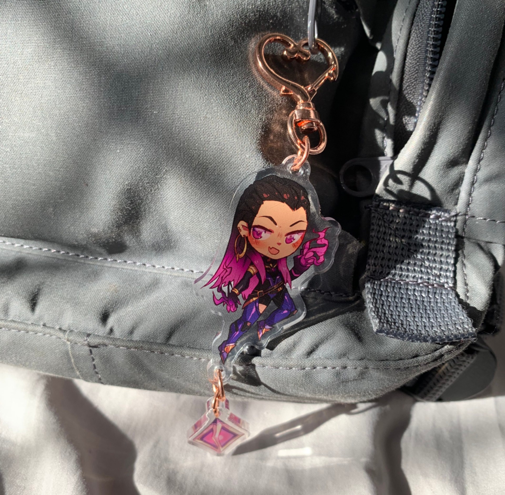 A Reyna charm from LOKIIart on Ana Valens' backpack.