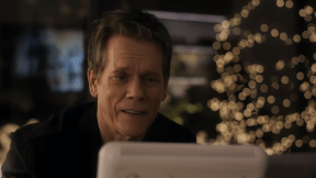 Kevin Bacon looking at his doorbell cam