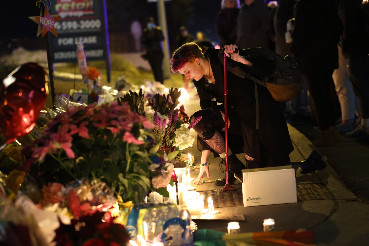 At Least 5 Dead And 18 Injured In Colorado Springs Gay Nightclub Shooting COLORADO SPRINGS, COLORADO - NOVEMBER 20: People hold a vigil at a makeshift memorial near the Club Q nightclub on November 20, 2022 in Colorado Springs, Colorado. Yesterday, a 22-year-old gunman entered the LGBTQ nightclub and opened fire, killing at least five people and injuring 25 others before being stopped by club patrons. (Photo by Scott Olson/Getty Images)