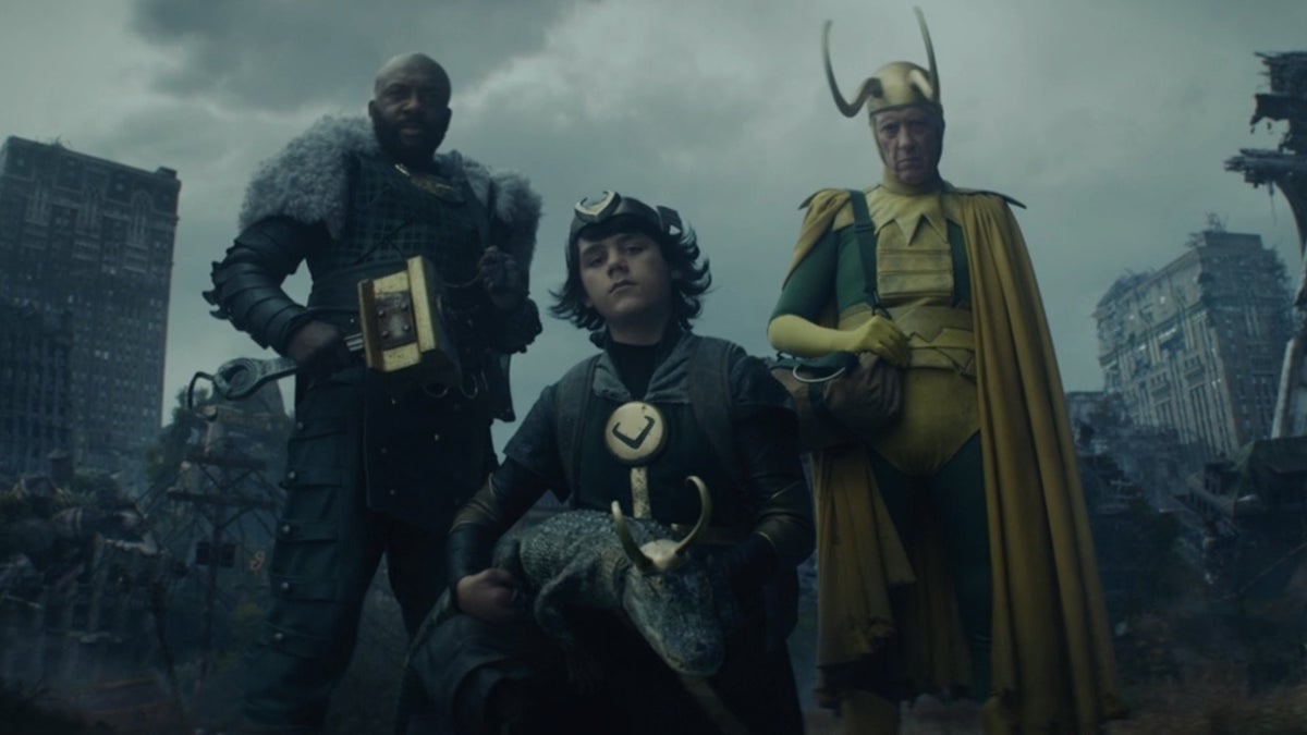 Boastful Loki, Alligator Loki, Kid Loki, and Classic Loki stare down at the camera with a ruined city behind them.