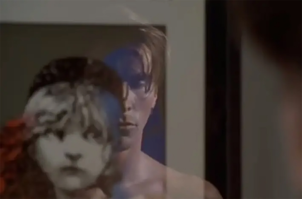 A Les Miserables poster and a shirtless Patrick Bateman (American Psycho) looking sad, seen in reflection.