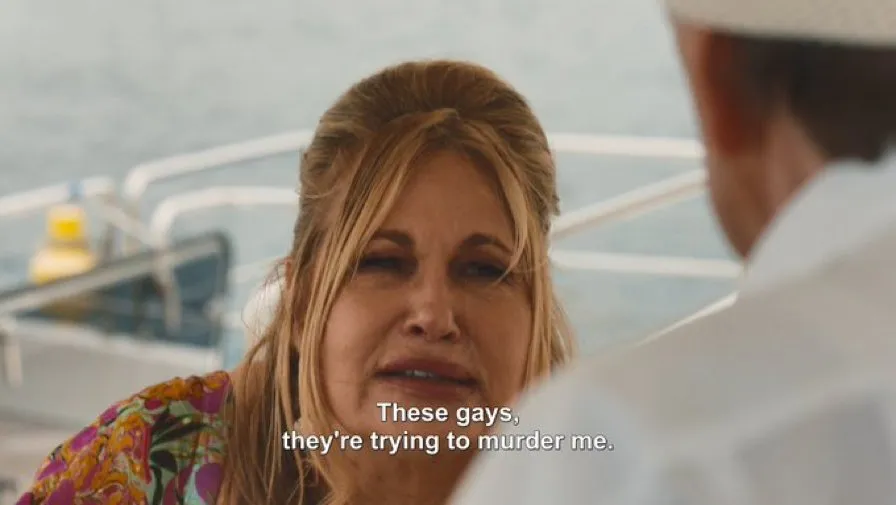 Jennifer Coolidge as Tanya in 'The White Lotus' season 2 finale. The closed caption reads "These gays, they're trying to murder me."