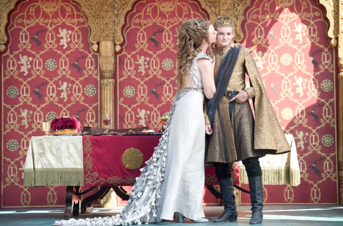 Newlyweds Joffrey Baratheon and Margaery Tyrell embrace at their wedding before it turns ugly