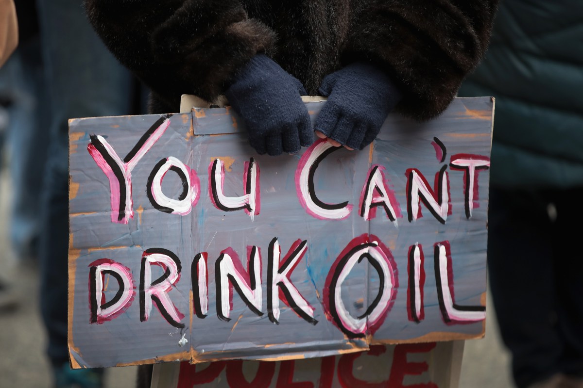 Close up of a protestor's sign, which reads, "You can't drink oil."