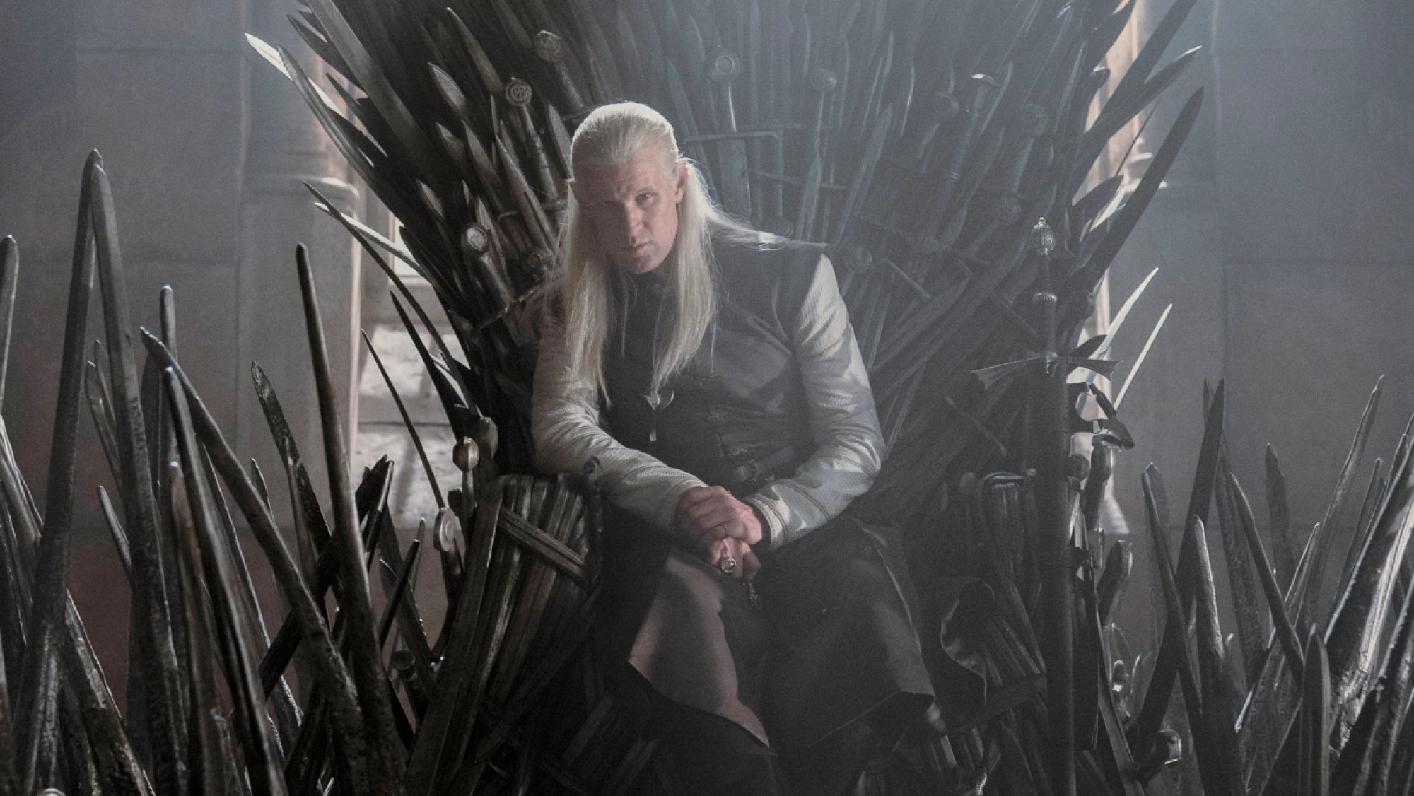 Matt Smith as Daemon Targaryen, sitting atop the Iron Throne in a promotional image for 'House of the Dragon'