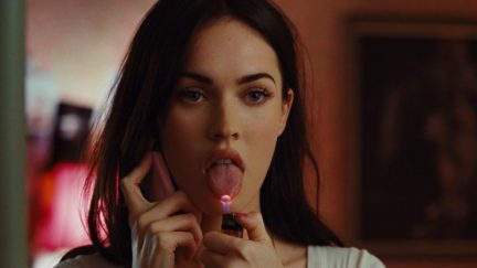 Jennifer (Megan Fox) holds a lighter to her tongue as she talks on the phone in 'Jennifer's Body'