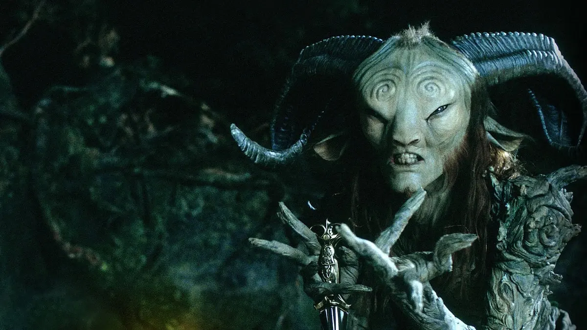 A mythical faun with horns emerges from the shadows in a scene from 'Pan's Labyrinth'