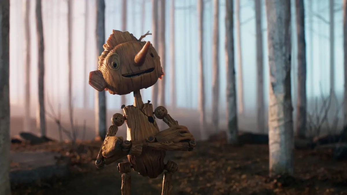 Pinocchio standing in a bright forest in Guillermo del Toro