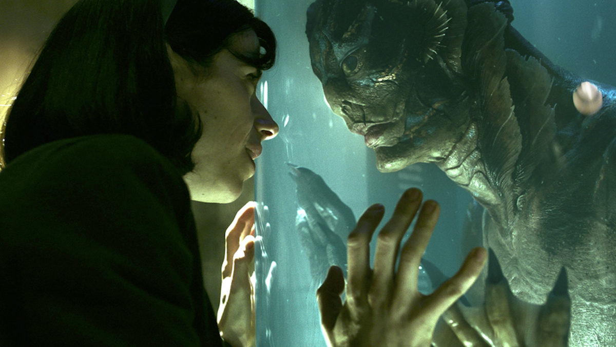 Elisa (Sally Hawkins) presses her forehead against a glass tank that contains an amphibious humanoid creature (Doug Jones) in a scene from 'The Shape of Water'