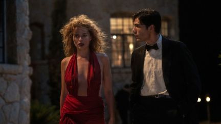Margot Robbie and Diego Calva walking in a scene from 'Babylon'