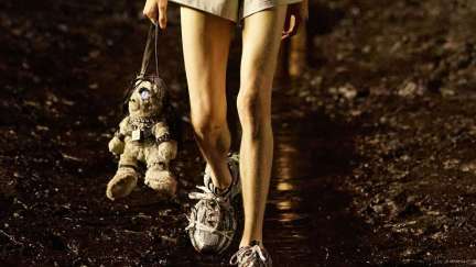Balenciaga model walking with teddy bear bag