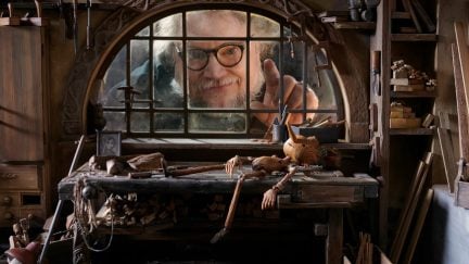 Guillermo del Toro behind a window on the set of Pinocchio. Image: Netflix.