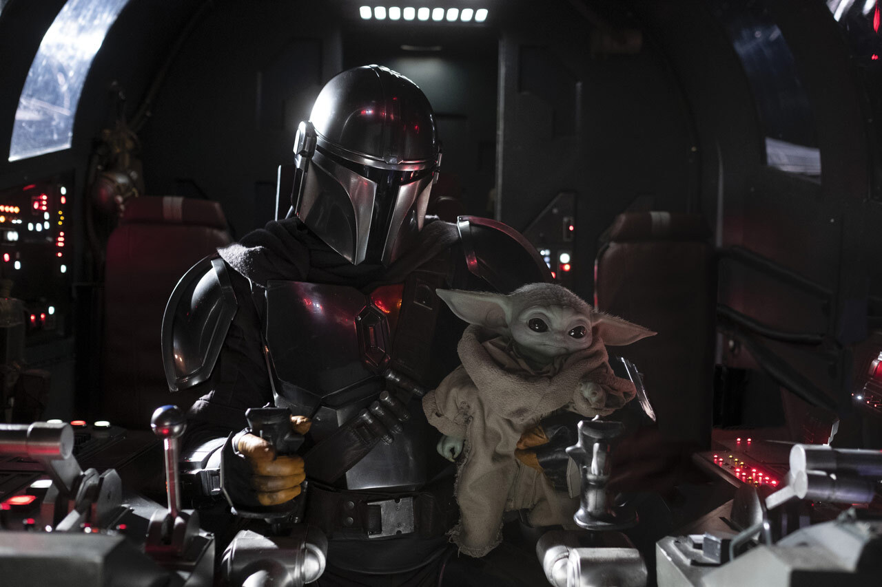 Pedro Pascal as The Mandalorian and Grogu sit in the cockpit of the Razor Crest