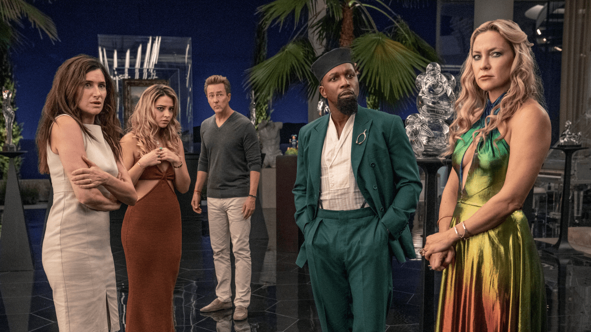 The characters of Glass Onion stand in Miles Bron's living room.