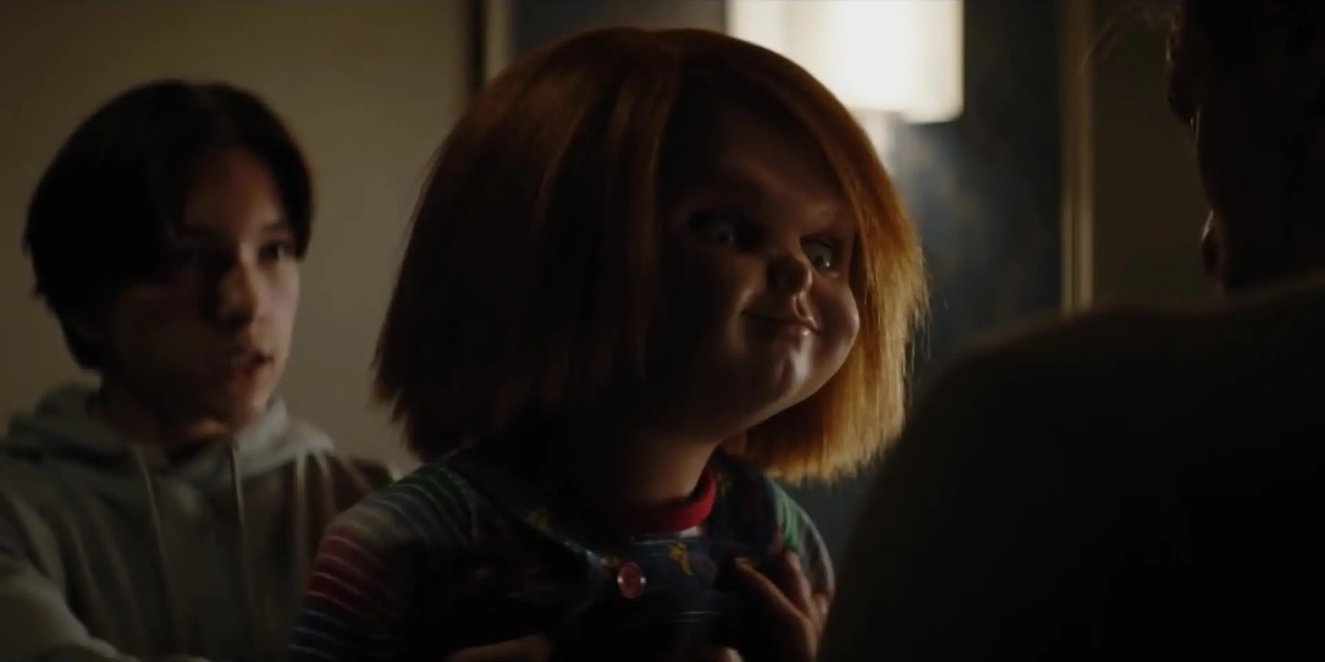 Junior holding Chucky to antagonize his dad in Chucky season 1