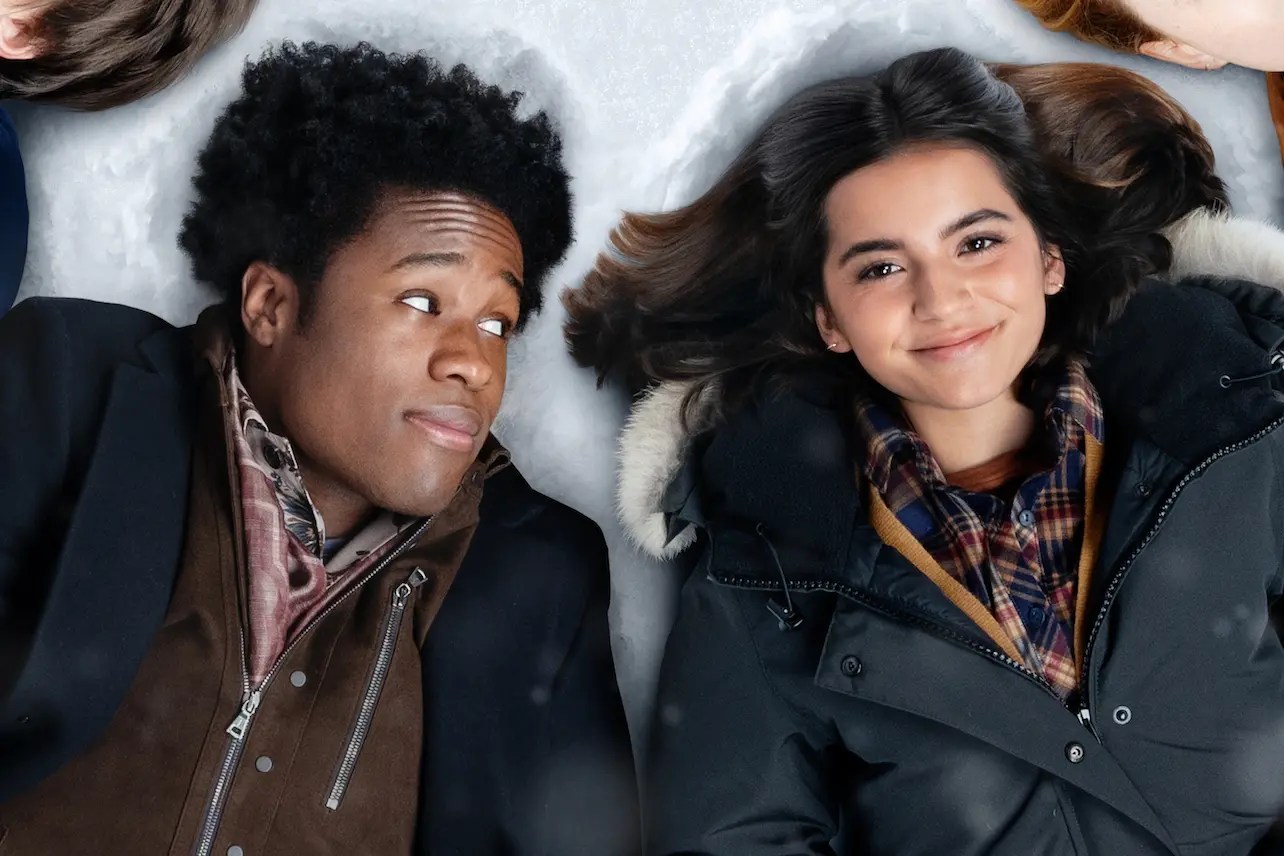 Julie (Isabela Merced) and Stuart (Shameik Moore) laying in the snow in 'Let It Snow'