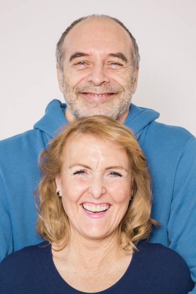 An elderly man and woman smiling.