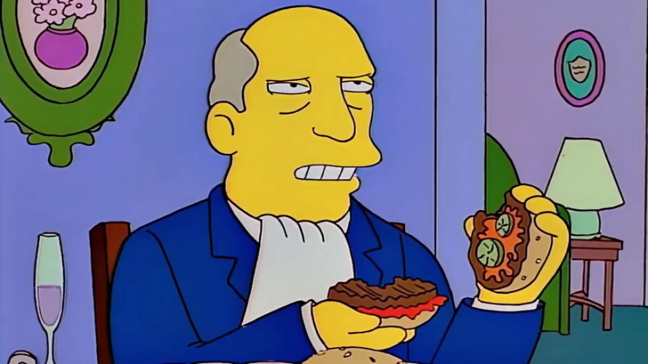 Superintendant Chalmers scowls, holding up the two halves of a hamburger.