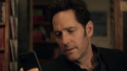 Scott Lang looks at his cell phone.