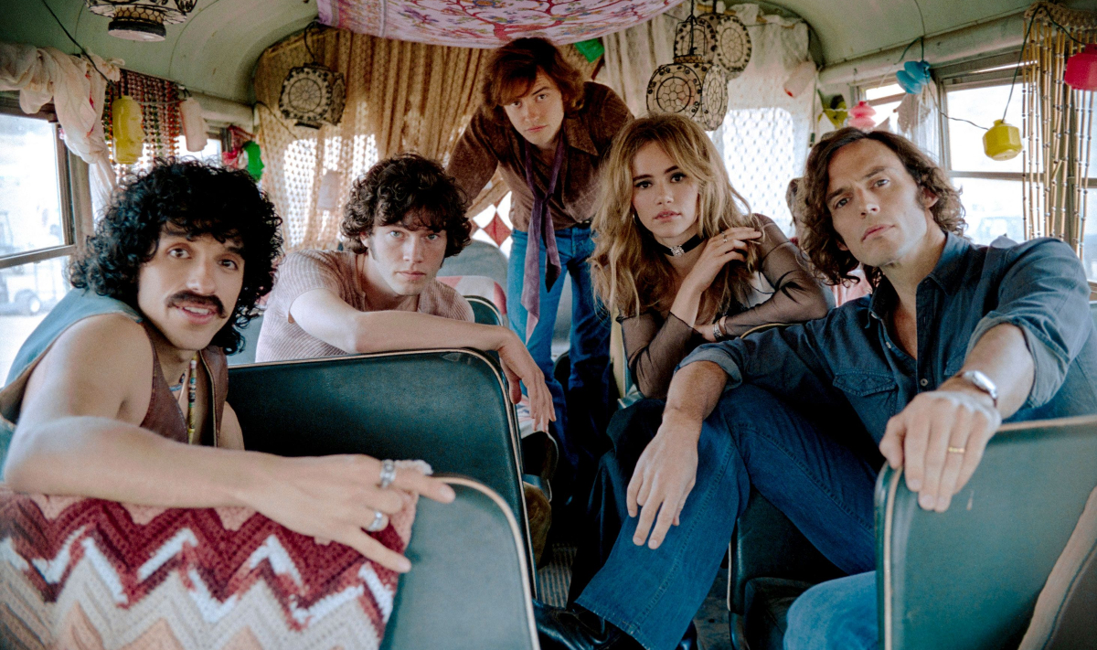 The cast of 'Daisy Jones and the Six' - a group of '70s musicians posing in a van.
