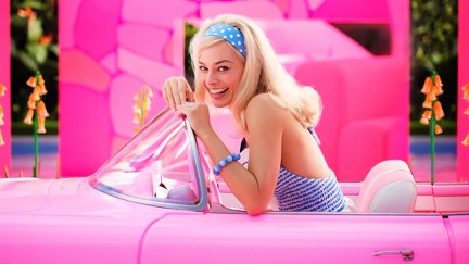 Margot Robbie's Barbie gives a big smile while sitting in a pink Corvette