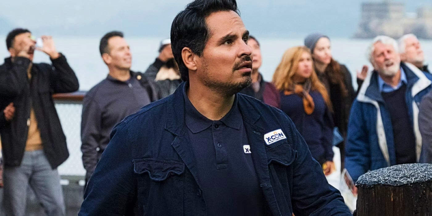 Luis (Michael Peña) looks up at the sky with a crowd of concerned onlookers 