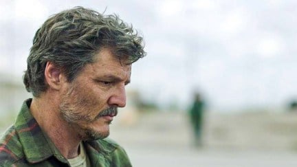 In a scene from 'The Last of Us,' Joel (Pedro Pascal) stands alone with a pensive expression on his face. His hair and beard are graying to convey how much time has passed since the start of the outbreak.