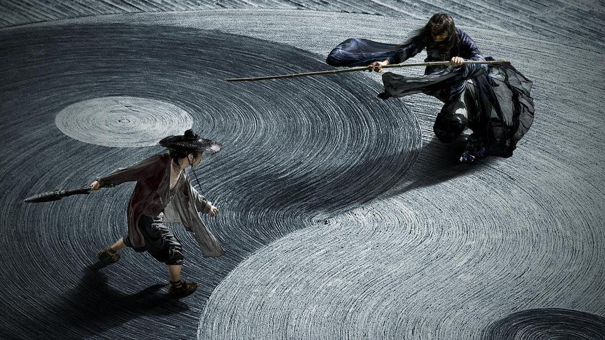 An aerial shot of two martial arts warriors facing each other with weapons in their hands in a scene from 'Shadow'