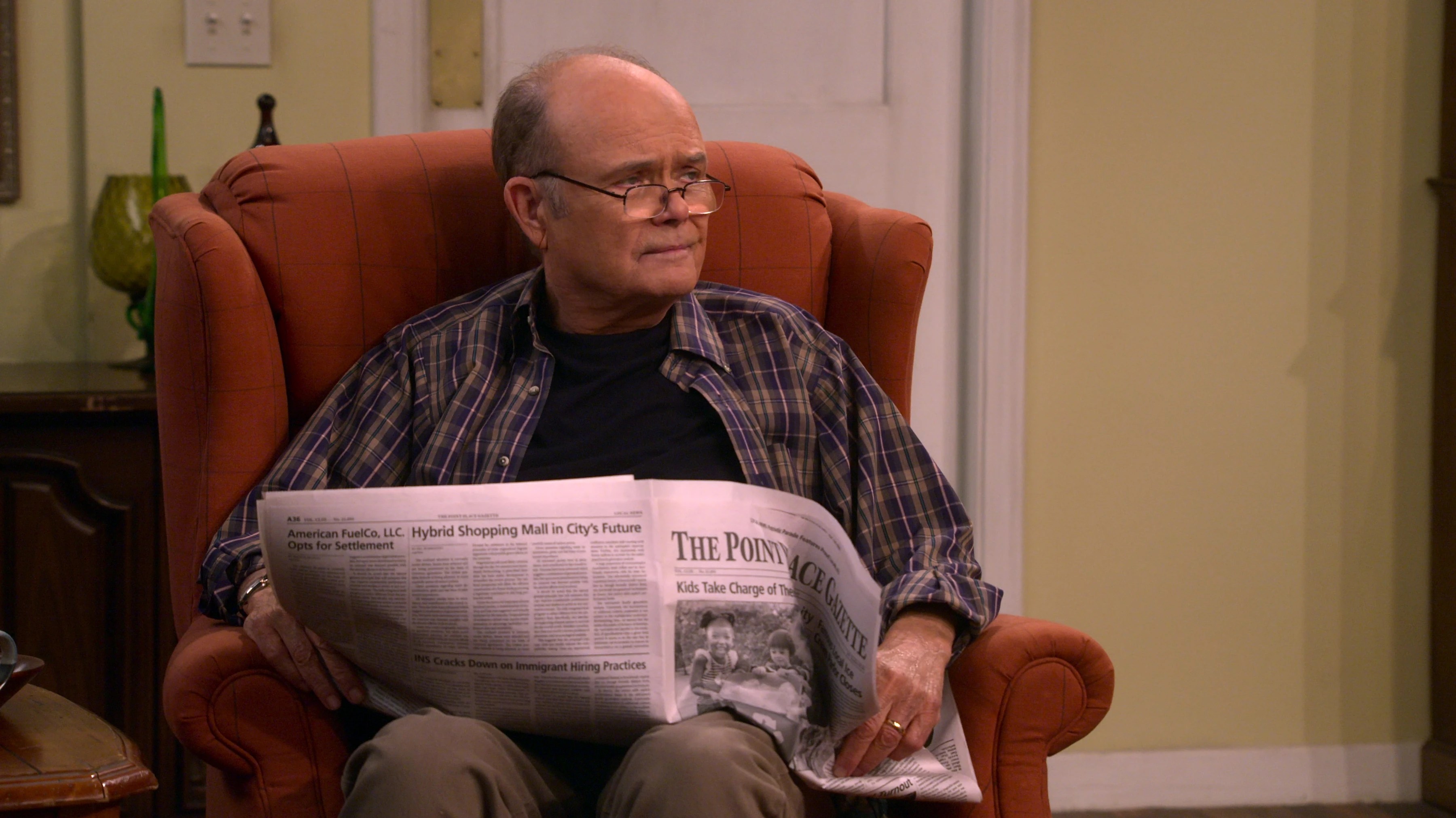Red Forman (Kurtwood Smith) peers over a newspaper in a scene from 'That '90s Show'