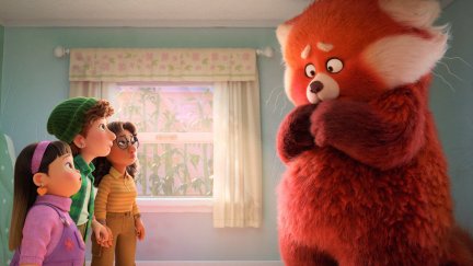 Three girls looking up at their friend who has transformed into a giant red panda in a scene from the animated film 'Turning Red'