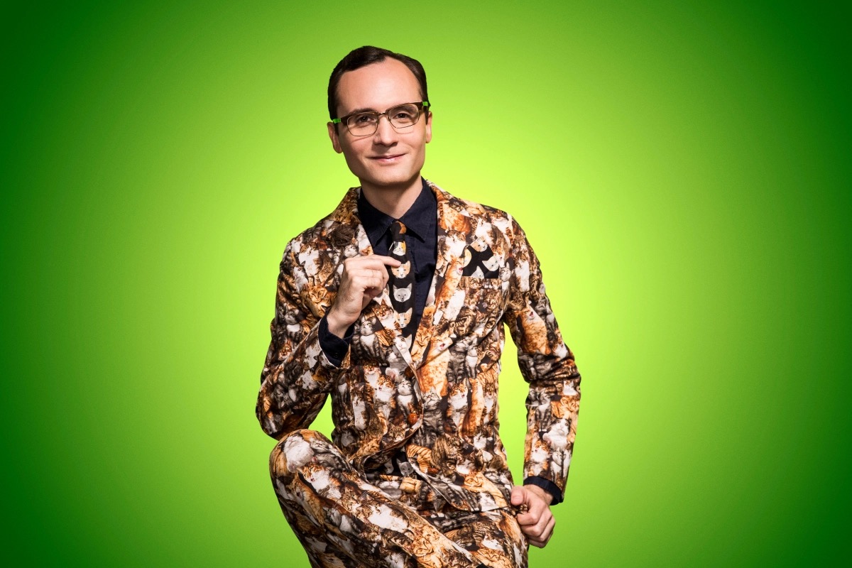 Native American Comedian Joey Clift in a suit printed with cats