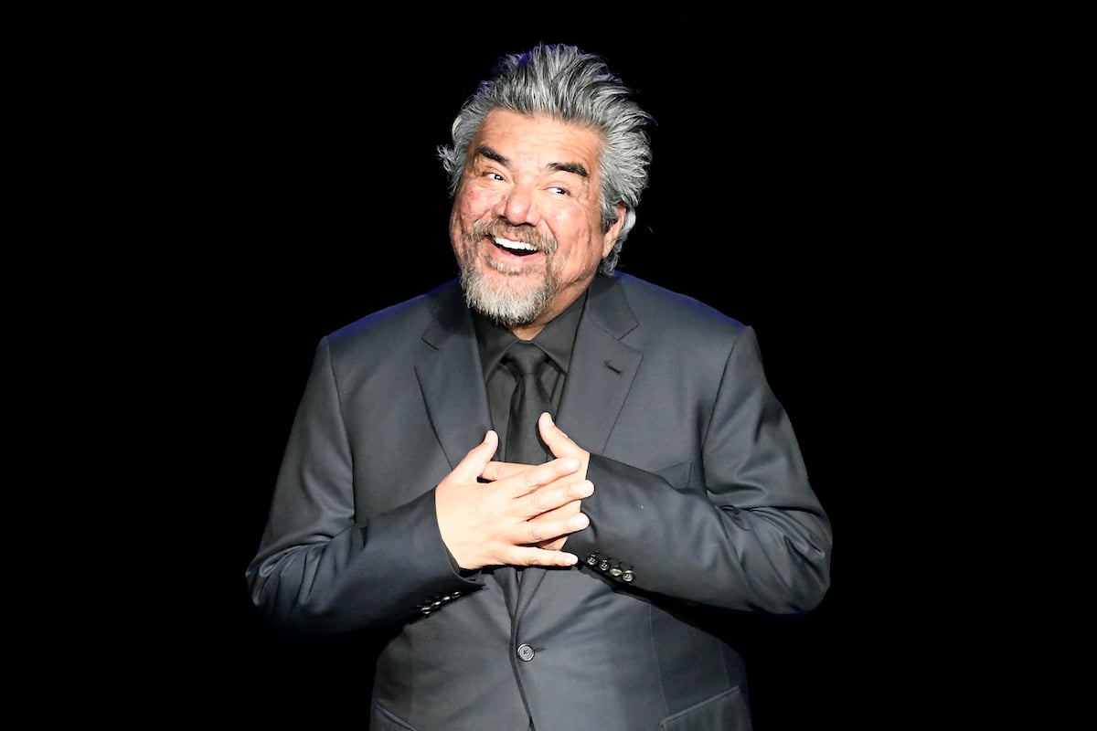 George Lopez puts his hands over his heart and smiles.