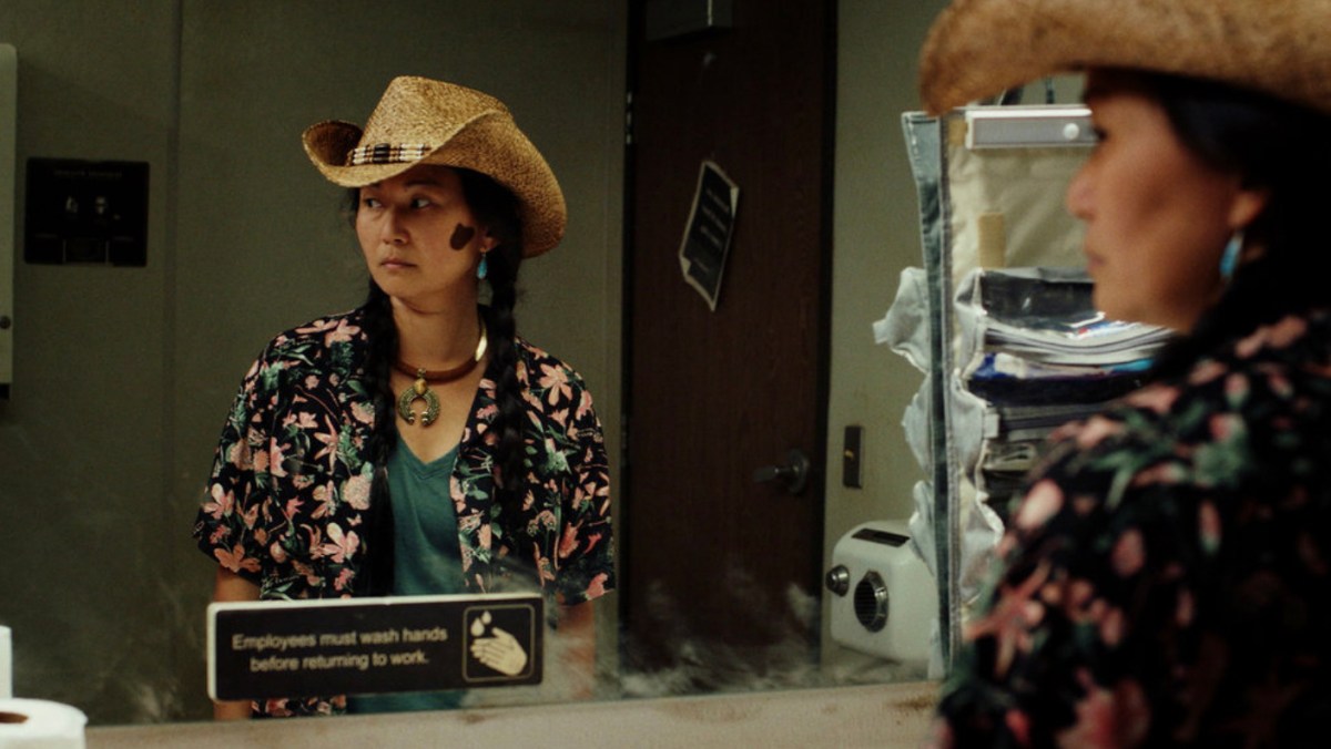 Hong Chau standing in front of a mirror in Poker Face