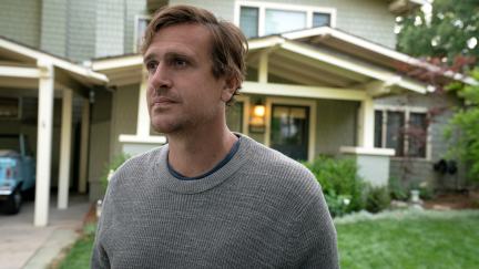 Jason Segel standing in front of a house in Shrinking