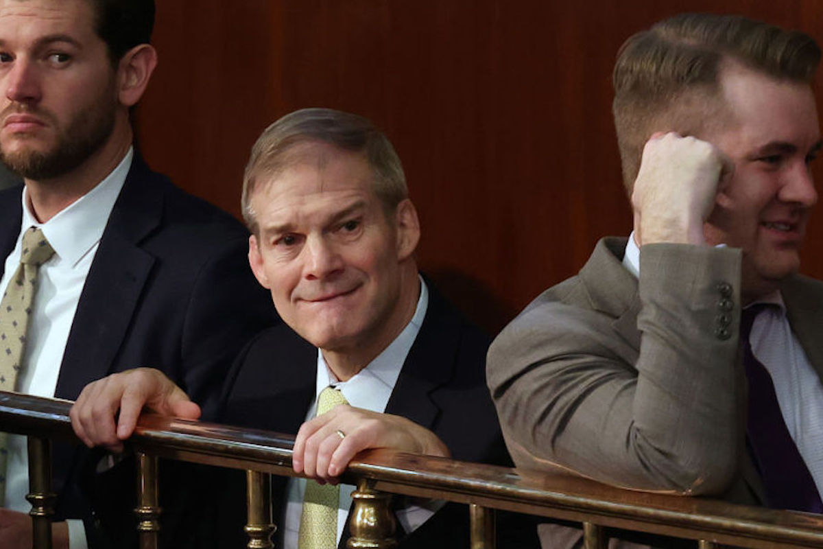Jim Jordan bites his lip and cringes while clinging a railing in the House.