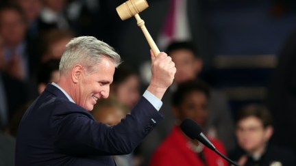 Kevin McCarthy grins and bangs a gavel in the House.