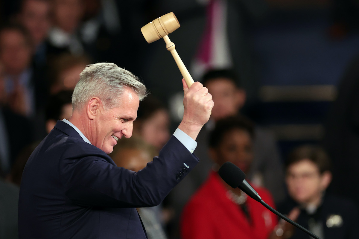Kevin McCarthy grins and bangs a gavel in the House.