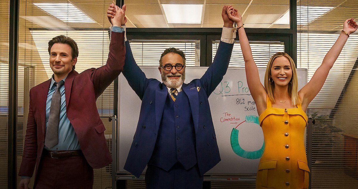 Chris Evans, Andy Garcia, and Emily Blunt in a still from 'Pain Hustlers.' They are standing next to each other, holding hands with arms raised in celebration.