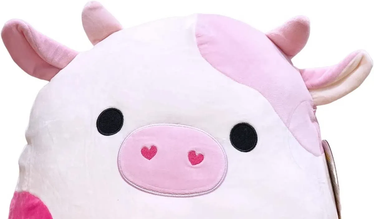 A two toned pink cow Squishmallow with heart shaped nostrils.