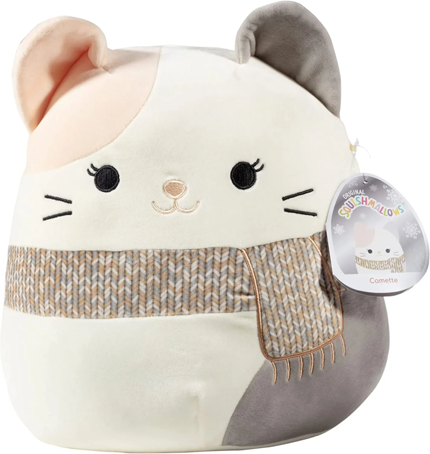 A grey, white and pink calico Squishmallow wearing a brown scarf