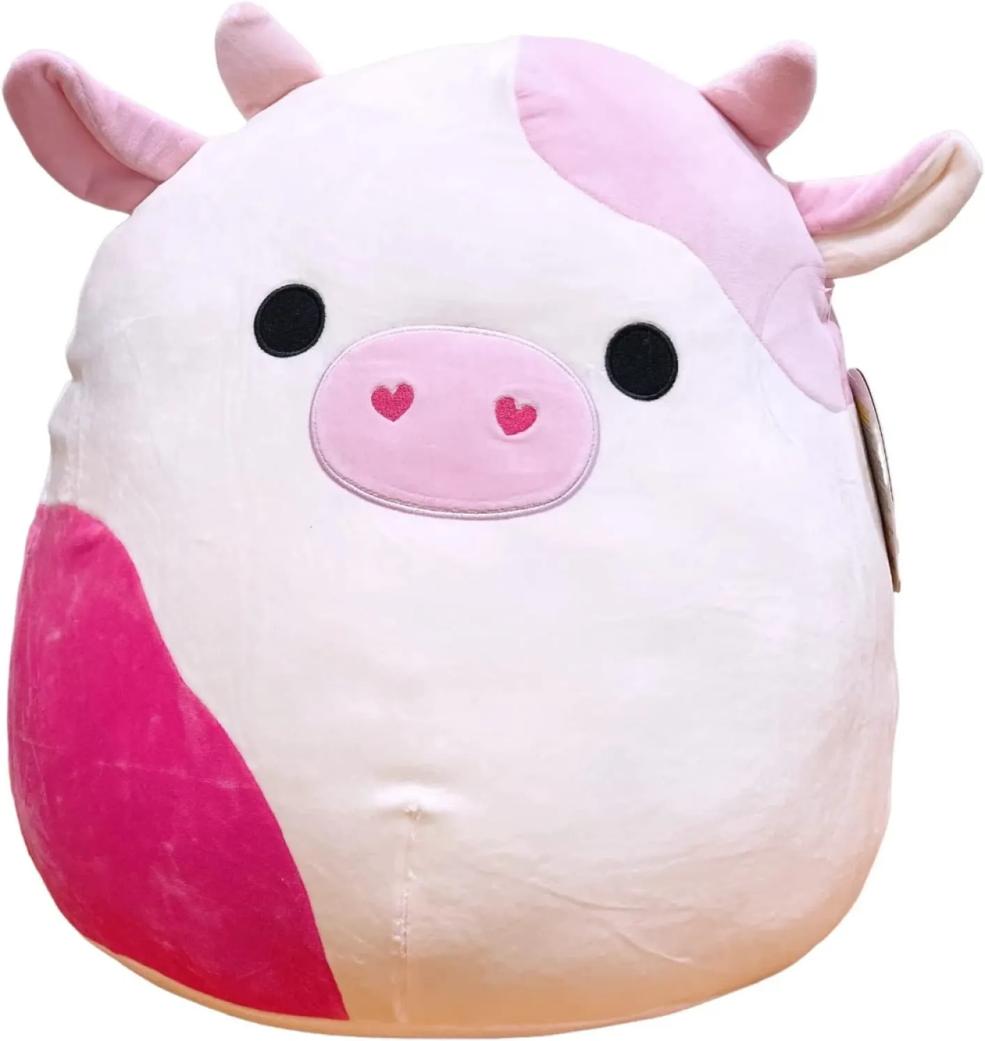 A three tone pink cow Squishmallow with heart shaped nostrils