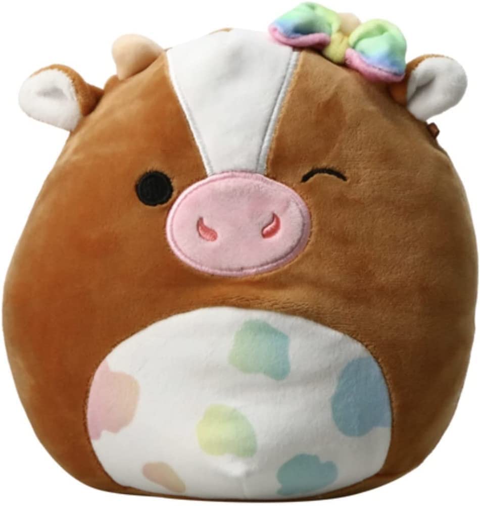 A pastel pink cow squishmallow with pink horms and rainbow fur on her stomach and headA pastel pink cow squishmallow with pink horms and rainbow fur on her stomach and headA pastel pink cow squishmallow with pink horms and rainbow fur on her stomach and head