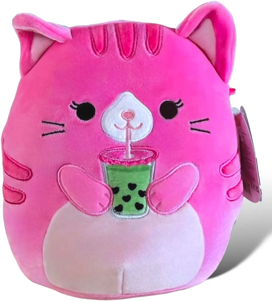 A pink cat Squishmallow drinking green boba tea