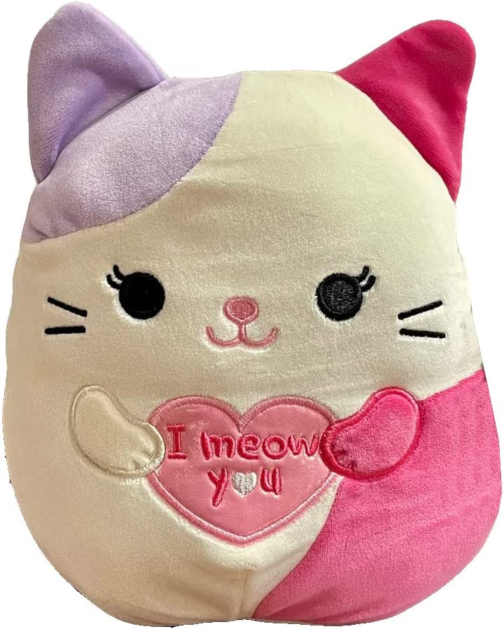 A white, purple and pink calico cat Squishmallow holding a pink heart saying "I meow you"