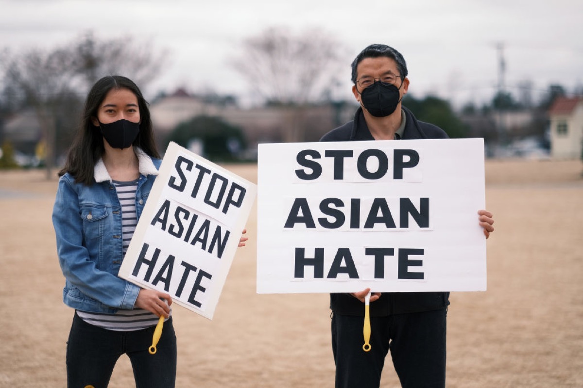 Two people holds up a signs that reads “STOP ASIAN HATE” at the Stop The Hate Rally Held In Virginia In Support Of Asian American Community.